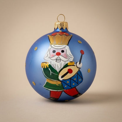 Nutcracker ball and drum on light blue