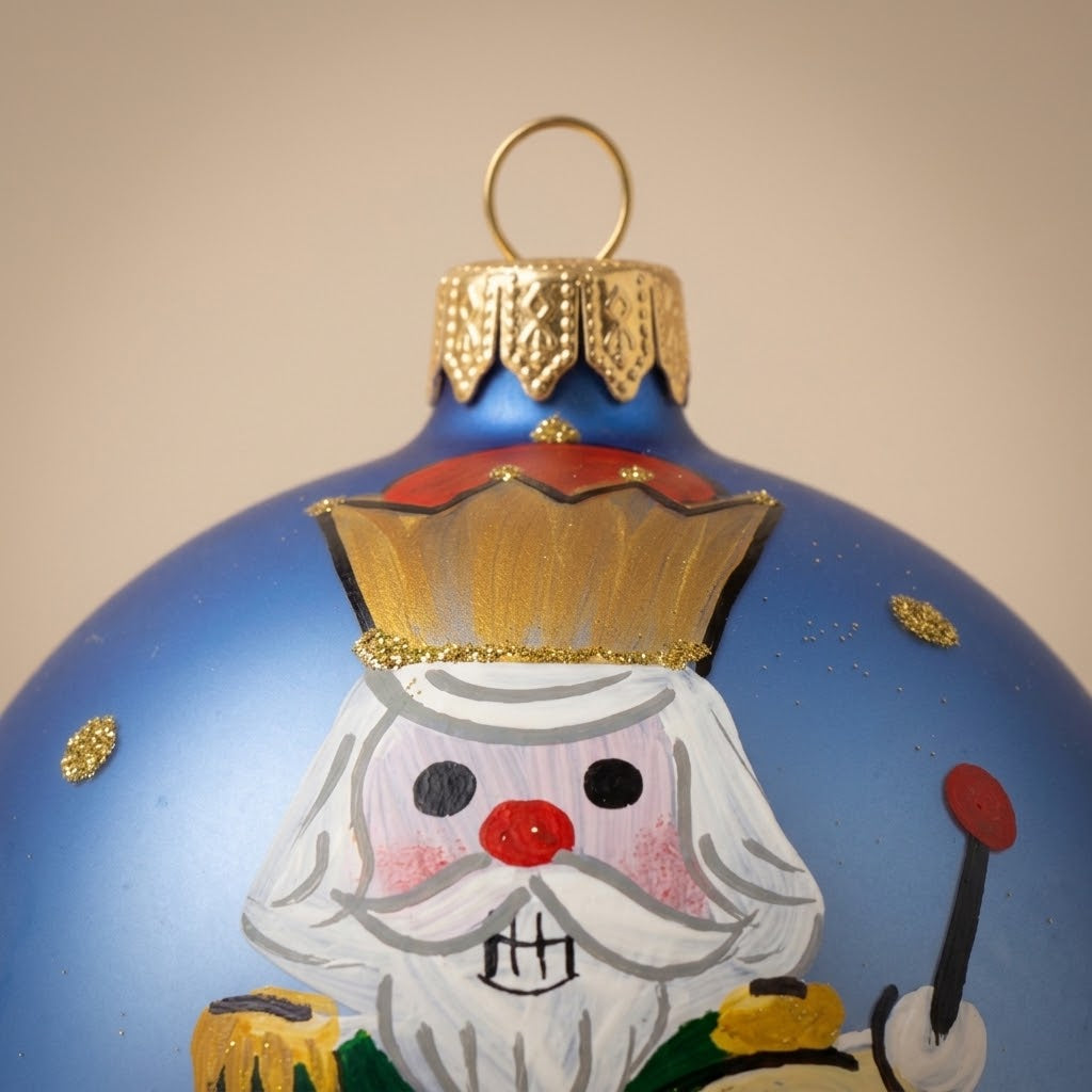 Nutcracker ball and drum on light blue