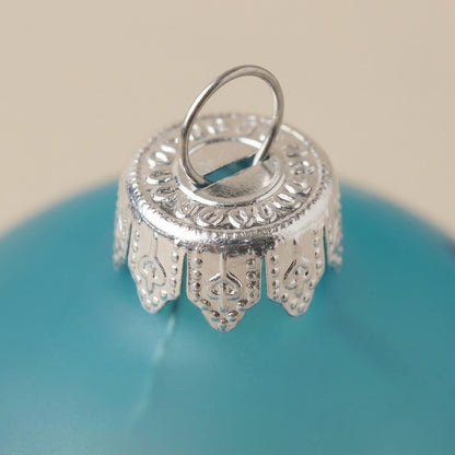 Ball bird and flowers on turquoise