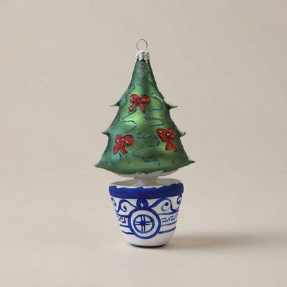Albero di Natale in vetro verde con fiocchi rossi e vaso bianco e blu