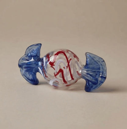 Clear candy with red stripes and a blue wrapper