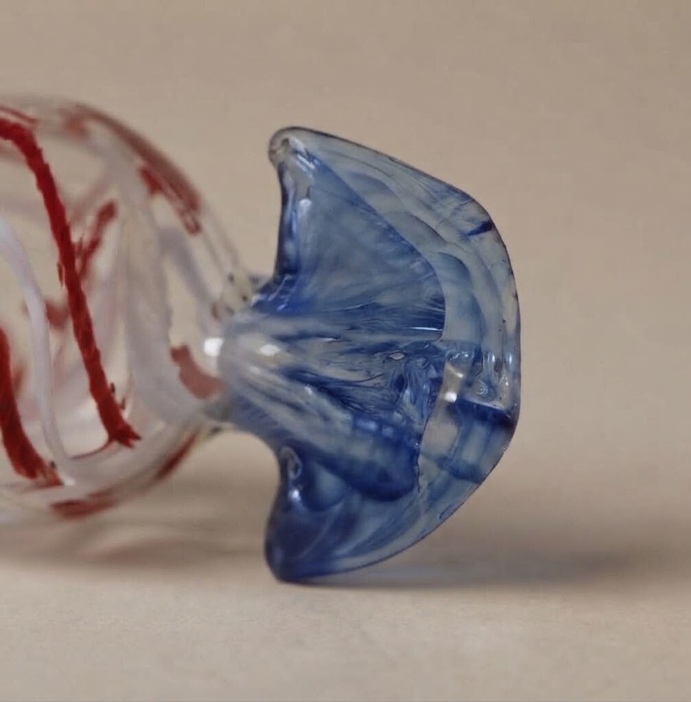 Close-up: Clear candy with red stripes and a blue wrapper