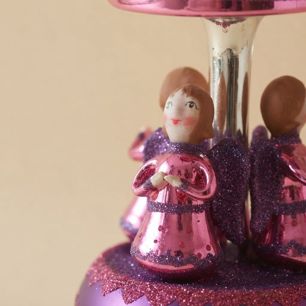 Design detail: pink Christmas carousel ornament with little angels