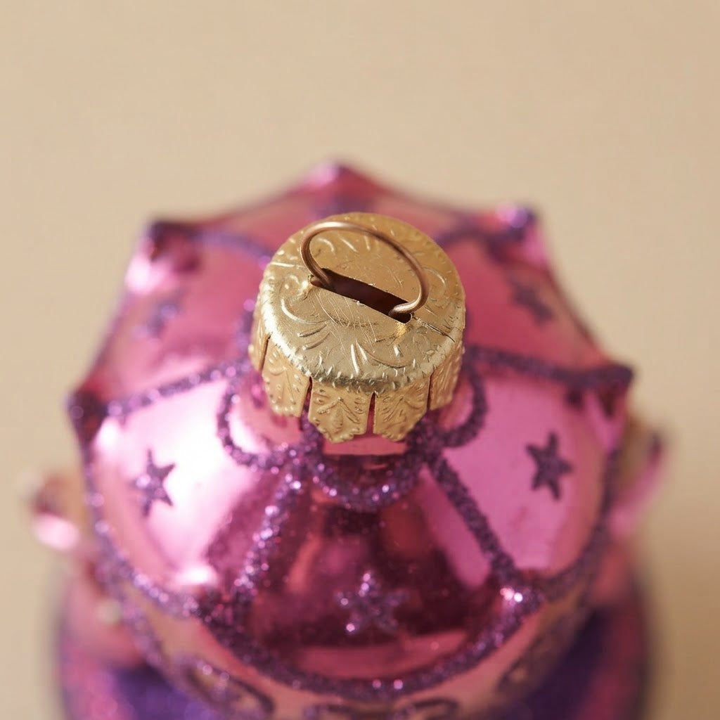 Close-up: pink Christmas carousel ornament with little angels