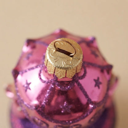 Close-up: pink Christmas carousel ornament with little angels