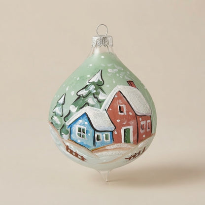 Christmas drop ornament with a snowy village on green
