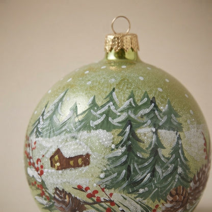 Decoration detail: Christmas ornament with a cabin in the snowy woods, 4 in (10 cm)