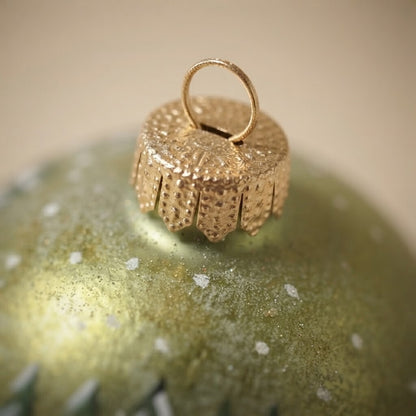Close-up: Christmas ornament with a cabin in the snowy woods, 4 in (10 cm)