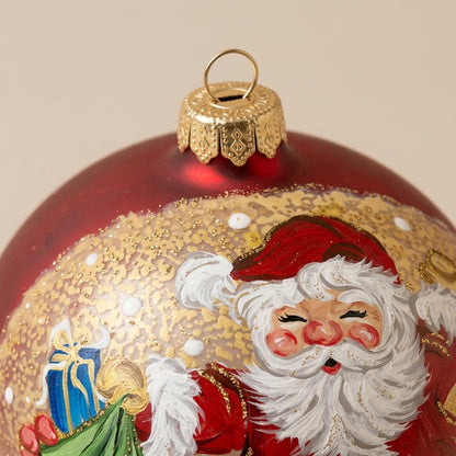 Dettaglio del decoro dipinto a pennello: Babbo Natale con i doni su fondo rosso e oro