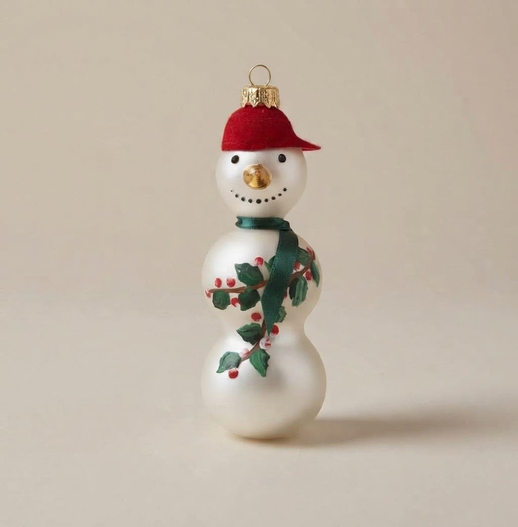 White glass snowman with red cap, green scarf and holly