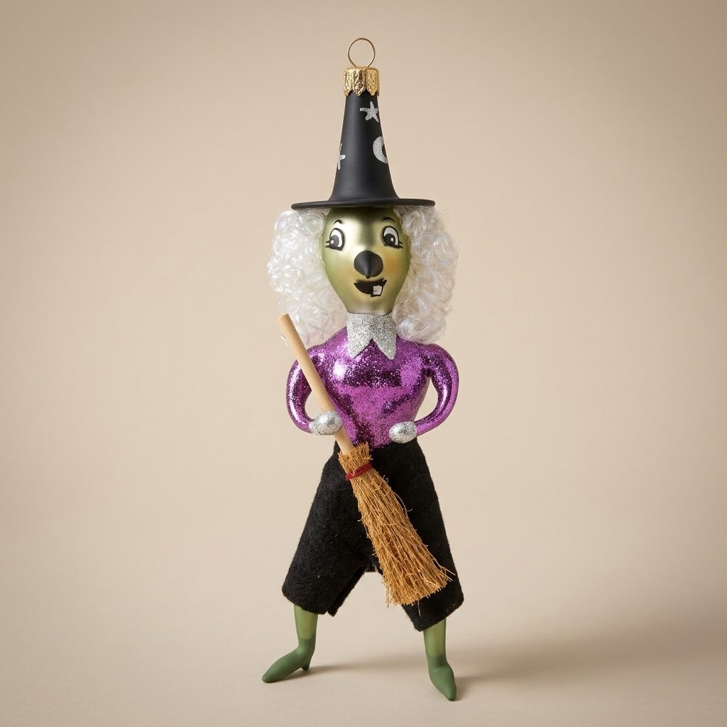 Glass Halloween witch with purple top, curly hair and broom