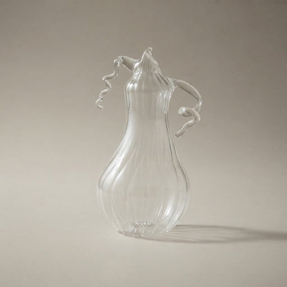 Clear glass pear-shaped pumpkin with ribs and curly tendrils