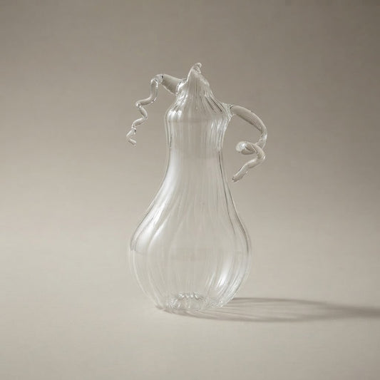 Clear glass pear-shaped pumpkin with ribs and curly tendrils
